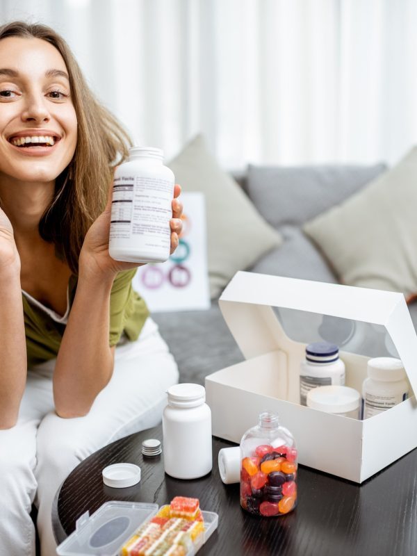 woman-with-nutritional-supplements-at-home-q52s5pg8ef5vctolyix2yvtkyu3yl1uivze9rh3akg